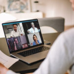 Woman discussing business with team over a video conference