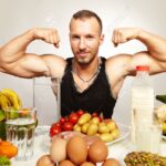 Healthy food for healthy fitness life - man in studio